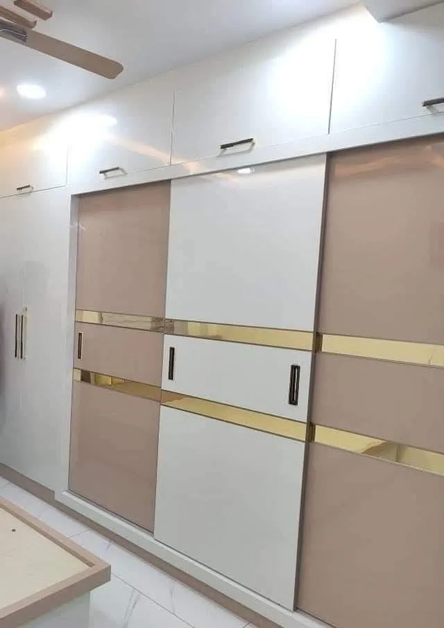 Sliding wardrobe design with acrylic finish in Kolkata home