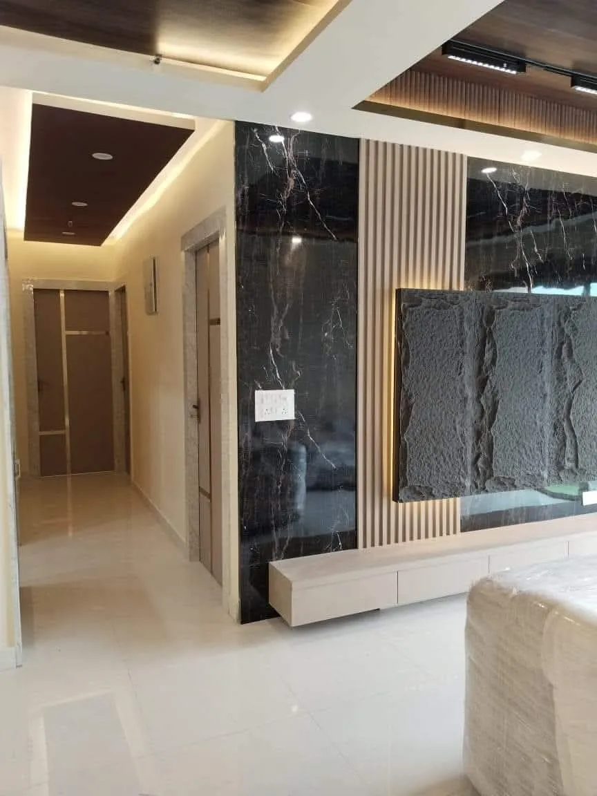 Modern Behala apartment interior featuring custom space-saving joinery and ambient false ceiling lighting.